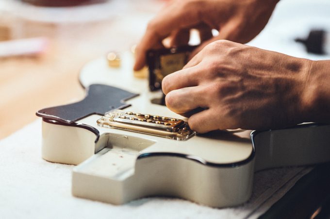 Guitar Repairs Being Performed By A Repair Technician